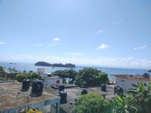 a view of the ocean from a balcony at Apart cercano al muelle y al malecón de Samana in Santa Bárbara de Samaná