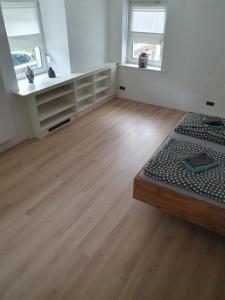 a white room with a bed and two windows at Burgberg in Altena