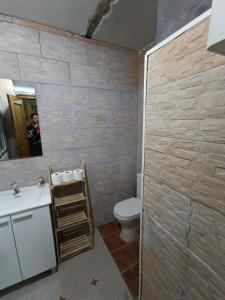 a bathroom with a toilet and a sink and a mirror at Chalet Venta del Aire Cortijo Terrón in Lanjarón +103 photos