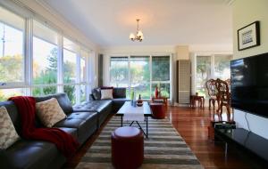 a living room with a couch and a tv at Rosebud Comfort Retreat in Rosebud