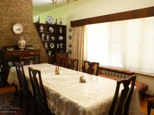 a dining room with a table and chairs and a window at Mieliefontein Karoo Guest Farm in Hanover Road