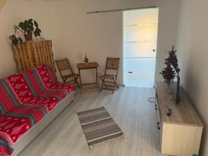 a living room with a couch and chairs and a table at Alex88 in Buşteni