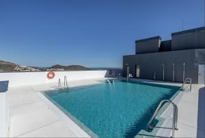 a swimming pool on the side of a building at ANSA Beach Apartments - Malaga - Skyline Suite in Málaga