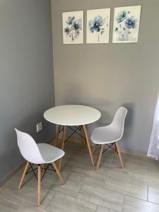 a table and two chairs in a room at York-R102 Airport Road - Modern Comfort in George
