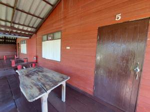 a room with a wooden wall with a wooden door at IngTawan Resort อิงตะวัน รีสอร์ท in Sing Buri