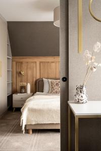 a bedroom with a bed and a vase on a table at Willa Amicus in Zakopane