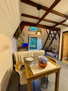 a dining room with a table and chairs and a window at Cabana na Serra Rs in São Francisco de Paula