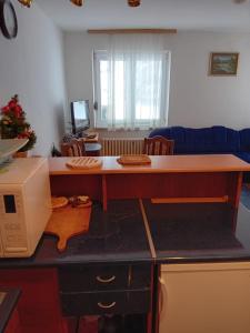 a desk in a living room with a computer at Tina in Jahorina