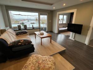 a living room with a couch and a tv at Sonnenblick Apartment sunview #rain-shower 2P bathtube BIG kitchen in Menden