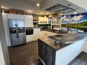 a kitchen with stainless steel appliances and a lake at Sonnenblick Apartment sunview #rain-shower 2P bathtube BIG kitchen in Menden