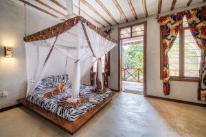 a room with a zebra print bed with at Makofi Guest House in Nungwi +166 photos