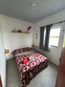 a bedroom with a bed with a red blanket at Cantinho da Rasa in Cabo Frio +31 photos