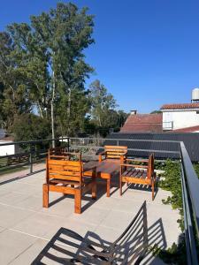 a group of benches sitting on a patio at La posta del vasco in Tanti