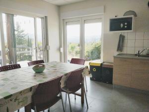 a kitchen with a table and chairs with a view at Maisonjoske in Beaulieu