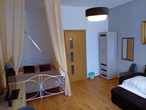 a bedroom with a bed and a television in a room at Amelia1 in Toruń