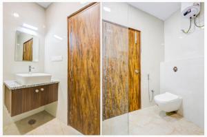 a bathroom with a shower and a toilet and a sink at The Grand Blue Hotel in Greater Noida