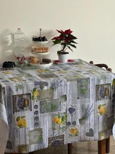 a table with a table cloth with fruits on it at La casa di Elvis in Ladispoli