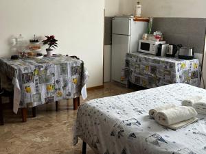 a kitchen with two beds and a refrigerator at La casa di Elvis in Ladispoli