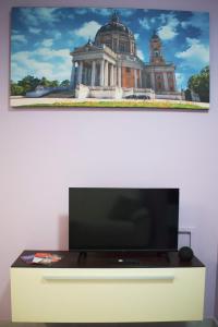 a flat screen tv sitting on top of a cabinet at Heimat 1 in Turin
