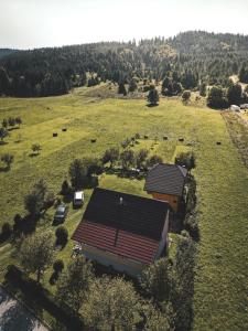 an aerial view of a house in a field at Holiday Home Vuković Plitvice Mountain Retreat in Saborsko
