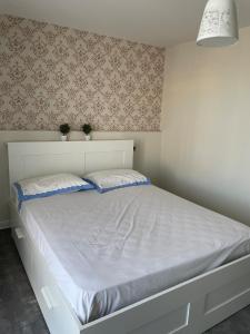 a white bed with two pillows in a bedroom at Il mucchietto in San Giovanni in Fiore