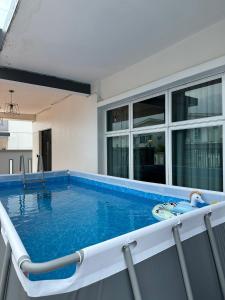 a large swimming pool on the balcony of a house at Fun Villa 6rm 12 to 22 pax Wifi Netflix BBQ SteamBoat Games Beach Water Park in Desaru