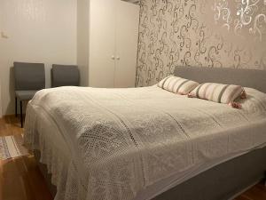 a bedroom with a bed with two pillows on it at Stor enebolig sentralt på Senja in Senja