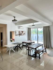 a room with ping pong tables in a room withwindows at Fun Villa 6rm 12 to 22 pax Wifi Netflix BBQ SteamBoat Games Beach Water Park in Desaru