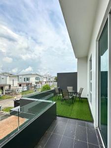 an open balcony with a table and chairs on it at Fun Villa 6rm 12 to 22 pax Wifi Netflix BBQ SteamBoat Games Beach Water Park in Desaru