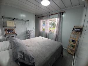 a bedroom with a bed and a window at Yin Garden Lodge Fortuna in Fortuna