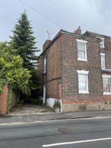 a brick building with a tree in front of it at Beverley Budget Inn in Beverley