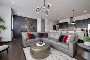 a living room with a couch and a kitchen at Two Townhomes- Rooftop Lounge- Hot Tub- City Views in Nashville