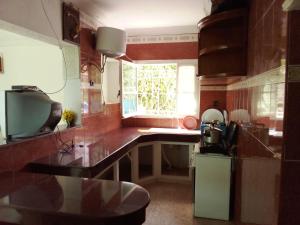 a kitchen with a counter and a window at Mother's House in Saïdia