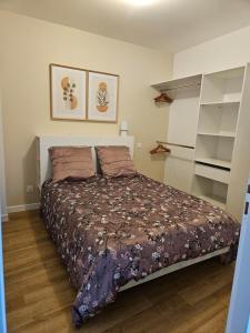 a bedroom with a bed in a room with shelves at L'authentique - Appartement 4 in Loudéac +6 photos