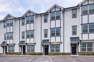 an apartment building with a parking lot at Two Elegant Townhomes Perfect for Large Groups in Nashville