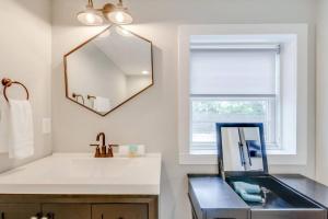 a bathroom with a sink and a mirror at Spacious and Peaceful Historic Franklin Quadplex in Franklin