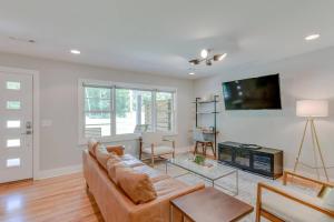 a living room with a couch and a tv at Lovely Three Bedroom Home Historic Franklin Quadplex in Franklin