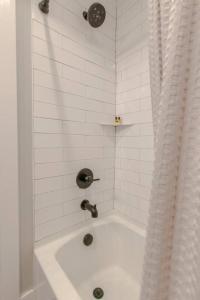 a white bath tub with a faucet in a bathroom at Lovely Three Bedroom Home Historic Franklin Quadplex in Franklin +67 photos