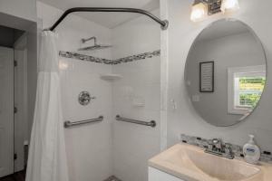 a white bathroom with a sink and a mirror at Sweet Jasper Suite-Summer Getaway in Jasper with Hot Tub in Jasper +9 photos