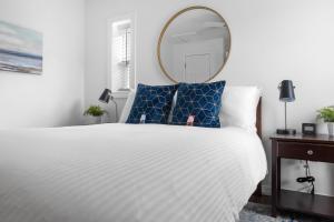 a bedroom with a white bed and a mirror at Sweet Jasper Suite-Summer Getaway in Jasper with Hot Tub in Jasper