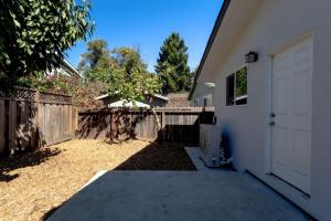 a house with a white door and a fence at PALO ALTO PRIVATE APARTMENT with kitchen, laundry and Near Stanford in East Palo Alto