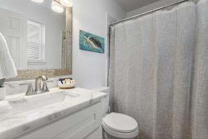 a bathroom with a sink and a toilet and a mirror at Coastal Retreat by the Beach in Long Beach +25 photos