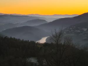 a view of a foggy valley at sunset at Le Cottage des Cerisiers in Saint-Paul-en-Cornillon