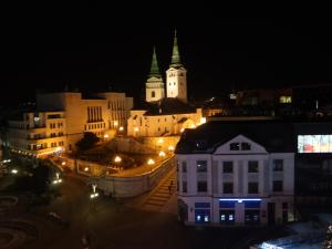 a view of a city at night with buildings at Apartmán Hollého in Žilina