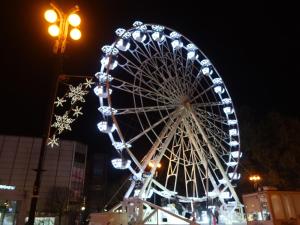 a large ferris wheel with christmas decorations on it at Apartmán Hollého in Žilina