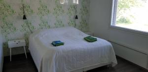 a bedroom with a bed with two towels on it at River landscape close to the centre, Himos 8km in Jämsä
