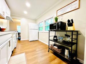a kitchen with a white refrigerator and a microwave at The Charming Location in Waycross