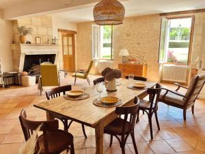 a living room with a wooden table and chairs at Domaine sur les coteaux de Loupiac in Loupiac-de-Cadillac