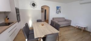 a kitchen and dining room with a table and a couch at VILLA BIANCA - Holiday home with Private pool in Privlaka