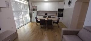 a kitchen and living room with a table and chairs at VILLA BIANCA - Holiday home with Private pool in Privlaka